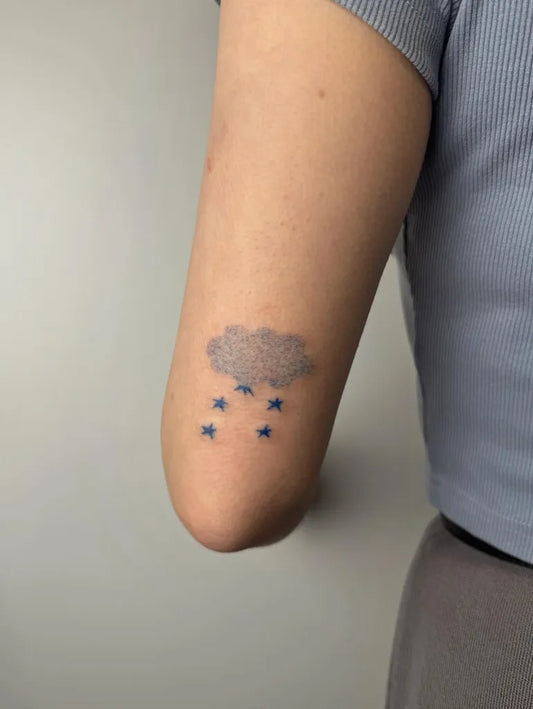 Small Minimalist Cloud with Rain and Stars Tattoo on Women Arm by @aurevoir.gabriel