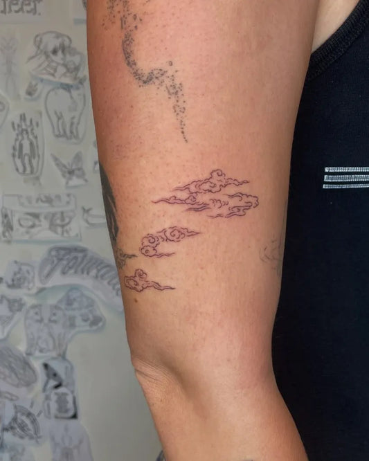 Small Minimalist Clouds Tattoo on Women Arm by @killakilla.ink