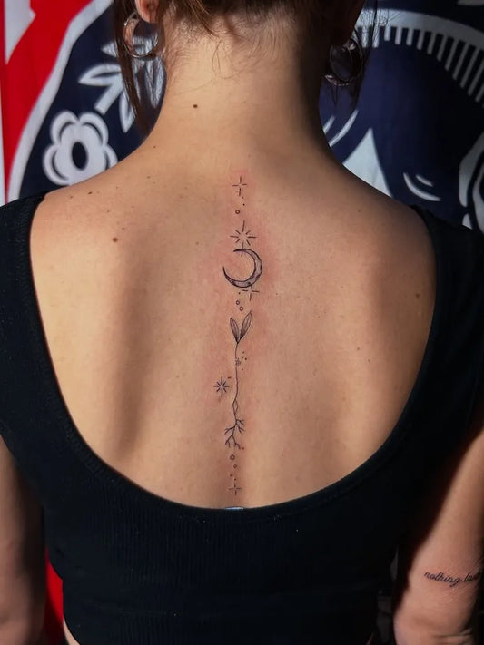 Small Minimalist Crescent Moon Sprig on Women Back Tattoo by @roostertattootr