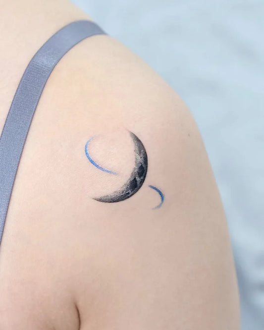 Small Minimalist Crescent Moon Tattoo on Women Shoulder by @tilda_tattoo