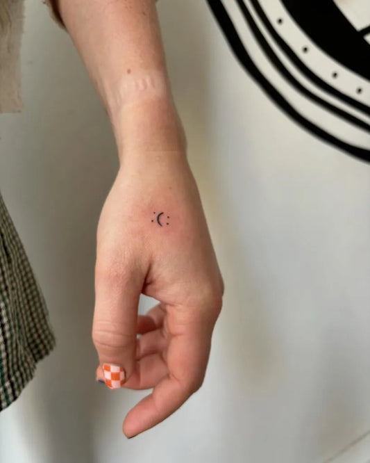 Small Minimalist Crescent Moon on Women Wrist Tattoo by @tamartielemantattoo