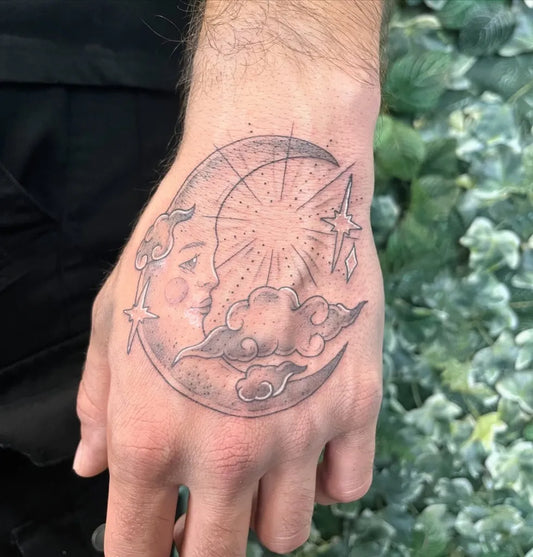 Small Minimalist Crescent Moon with Face and Stars on Men Hand Tattoo by @sproutedbeanstattoo