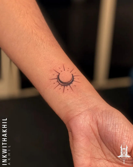 Small Minimalist Crescent Moon with Rays Tattoo on Women Wrist by @inkwithakhil