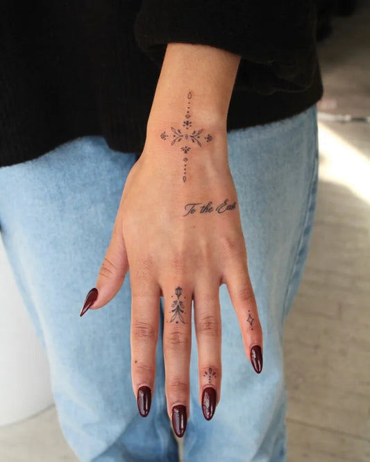 Small Minimalist Cross and Kanji on Women Wrist Tattoo by @softchicktattoo