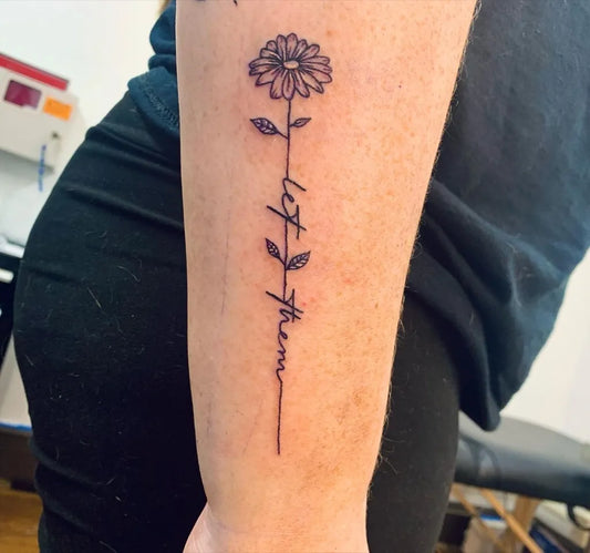 Small Minimalist Daisy Let Them on Women Arm Tattoo by @raymond.savanna