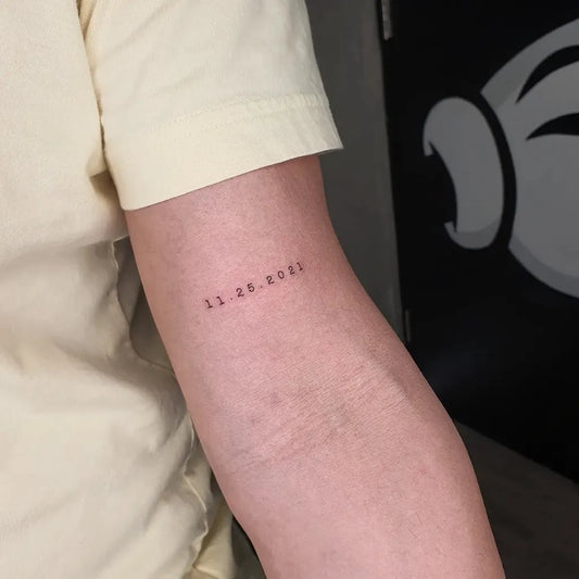 Small Minimalist Date Number Tattoo on Women Arm by @alexherndzstudio