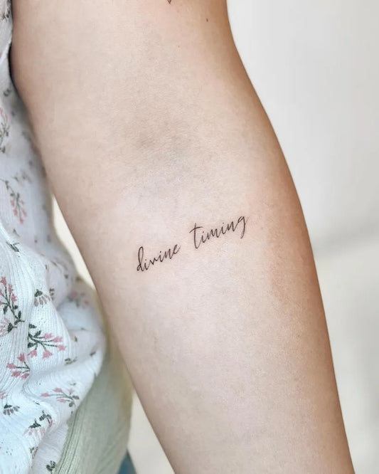 Small Minimalist Divine Timing on Women Arm Tattoo by @cha.tattoo