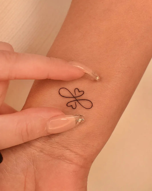 Small Minimalist Double Infinity Heart on Women Wrist Tattoo by @tinytattooinc