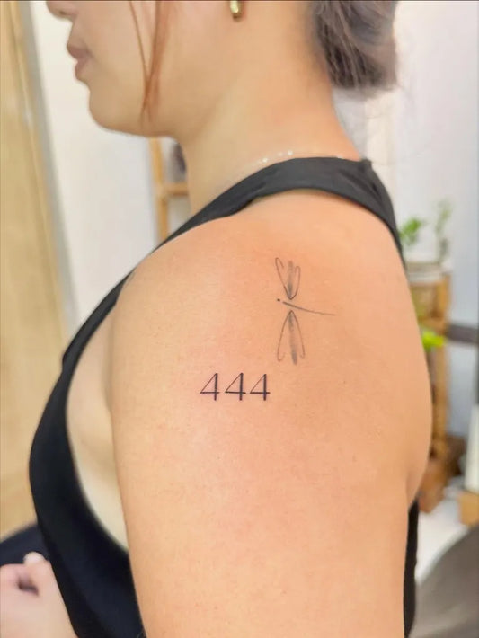 Small Minimalist Dragonfly and 444 on Women Shoulder Tattoo by @des.piercinkstudio