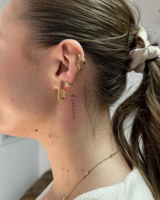 Small Minimalist Dreamy Word on Women Neck Tattoo by @buza_ink