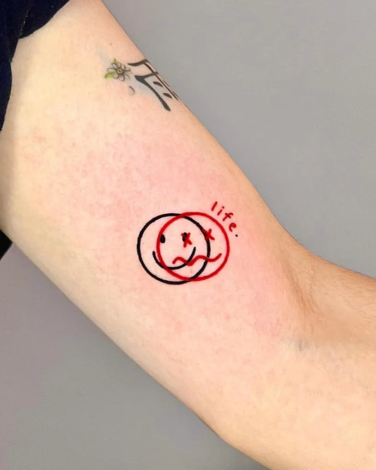 Small Minimalist Dual Smiley Faces with Life Text on Women Arm Tattoo by @armink_tattooer
