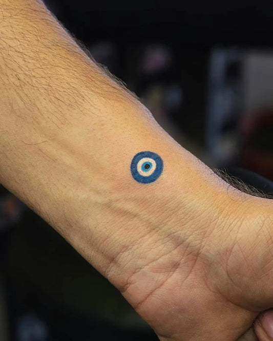 Small Minimalist Evil Eye on Men Wrist Tattoo by @aztattoozz