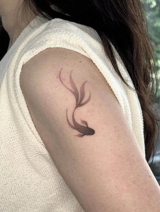 Small Minimalist Fish Tattoo on Women Upper Arm by @leejeong_tt