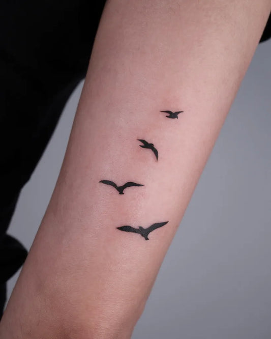 Small Minimalist Flock of Birds Tattoo on Women Arm by @tattooist_dulgi