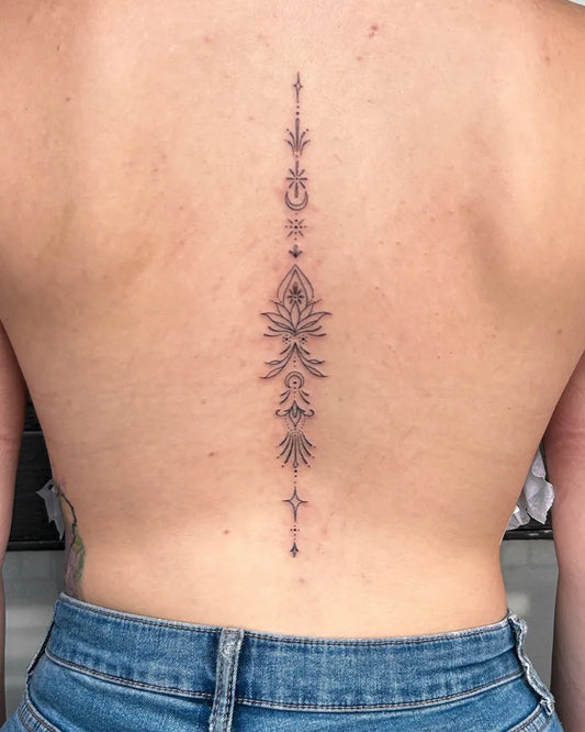 Small Minimalist Floral Mandala on Women Spine Tattoo by @michaela_leightattoo