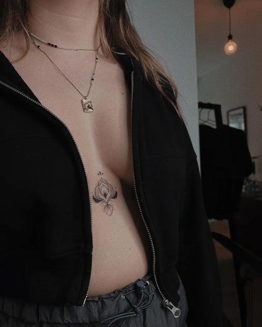 Small Minimalist Floral Motif on Women Sternum Tattoo by @viktoriagolebowska