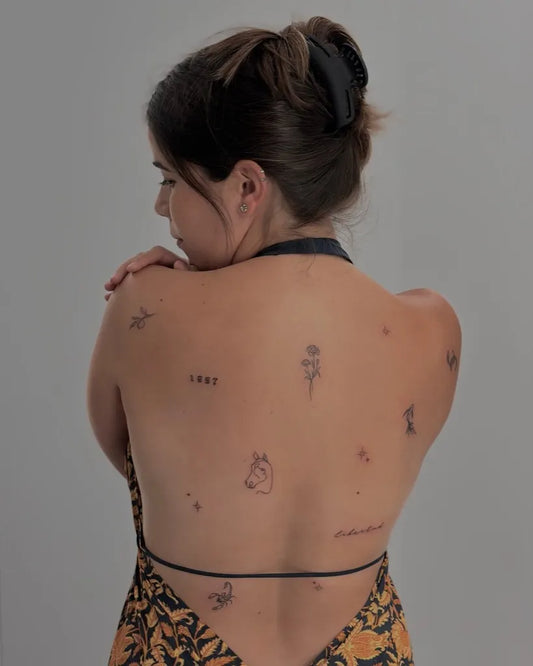 Small Minimalist Flower Stars Horse on Women Back Tattoo by @efa_tattoo