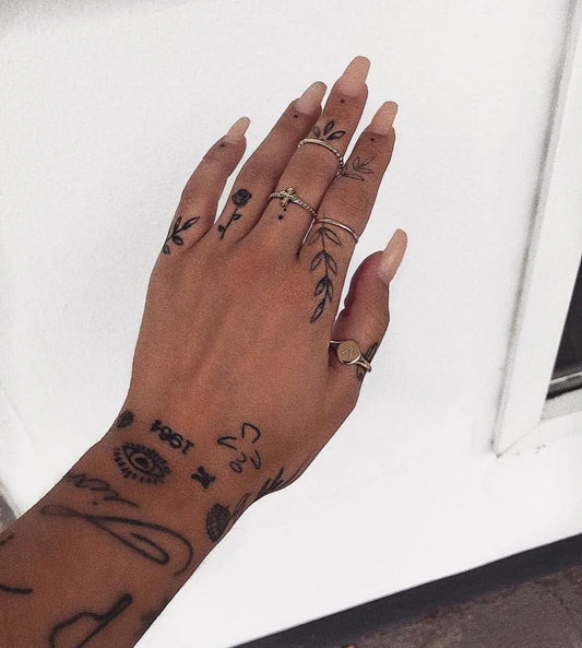 Small Minimalist Flowers and Eye on Women Fingers Tattoo by @tinytattooinc