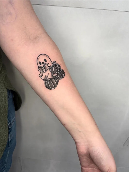 Small Minimalist Ghost with Pumpkins Tattoo on Women Forearm by @dollydolltattoos