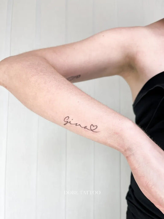 Small Minimalist Gina Name on Women Arm Tattoo by @dobe.tattoo