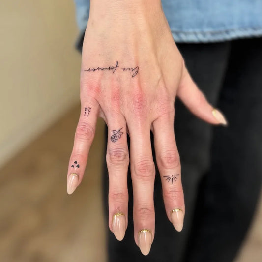 Small Minimalist Handwriting Script and Symbols on Women Hand Tattoo by @sugarvenomtattoo