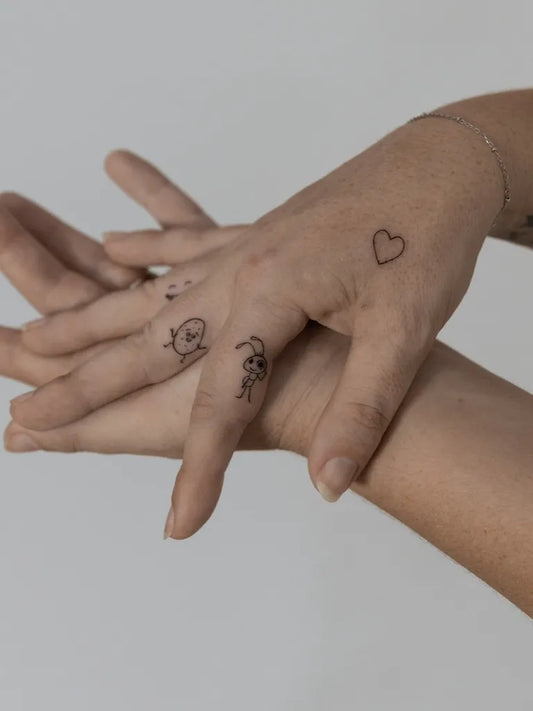 Small Minimalist Heart Fish Dog on Women Hand Tattoo by @loftn5tattoo_bali