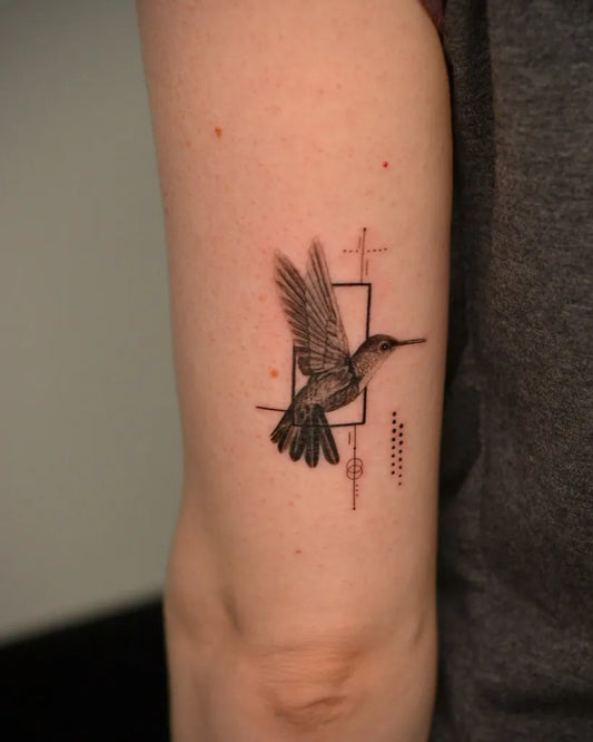 Small Minimalist Hummingbird with Geometric Frame on Women Arm Tattoo by @rimatattoo