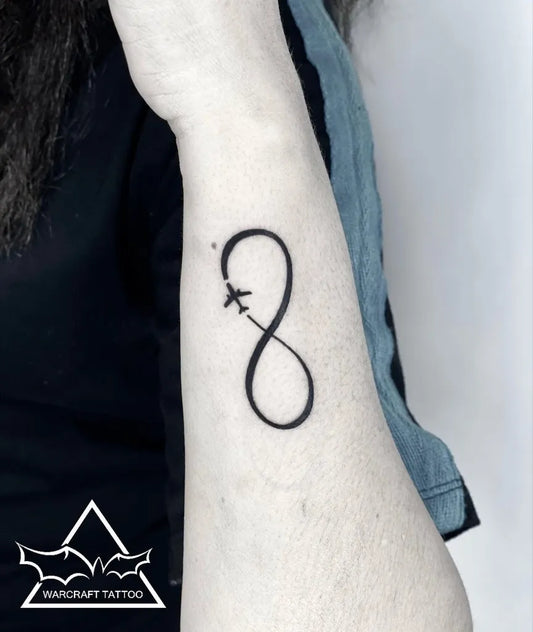Small Minimalist Infinity Airplane Tattoo on Women Wrist by @warkrafttattoostudio