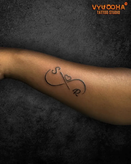 Small Minimalist Infinity Couple Initials Tattoo on Women Forearm by @ramanathapuramtattooartists