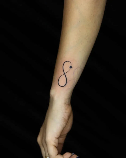 Small Minimalist Infinity Symbol Tattoo on Women Wrist by @nikhil_thetattooart_