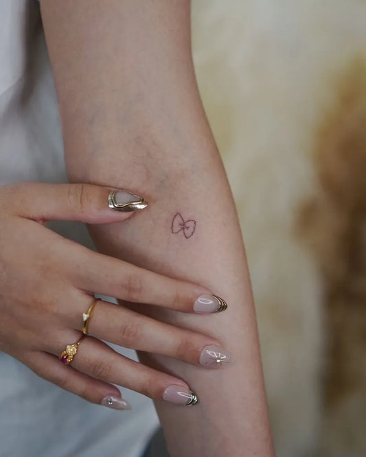 Small Minimalist Infinity Symbol on Women Arm Tattoo by @davekulla.tattoo