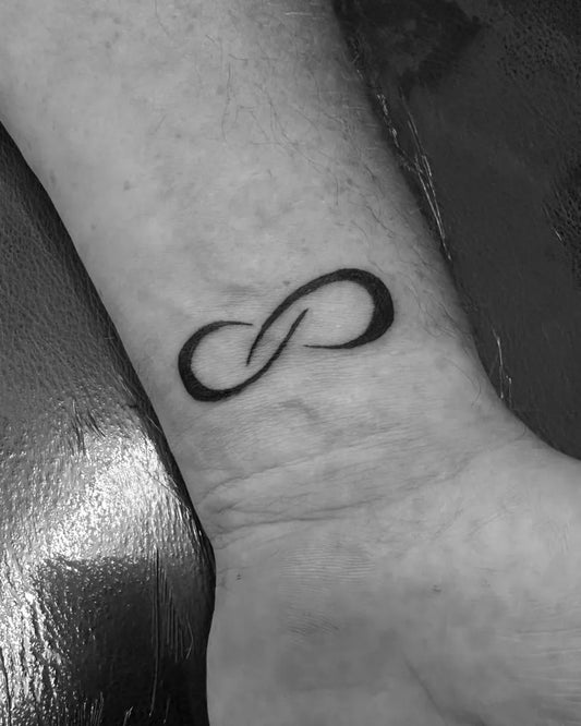 Small Minimalist Infinity Tattoo on Men Wrist by @tattoo.by.kaka