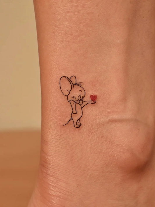 Small Minimalist Jerry Mouse Holding Heart on Women Ankle Tattoo by @tinytattooinc