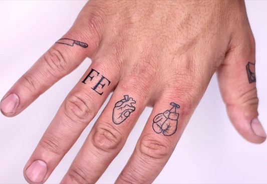 Small Minimalist Knife Heart Boxing Gloves on Men Fingers Tattoo by @ninia.tattoo