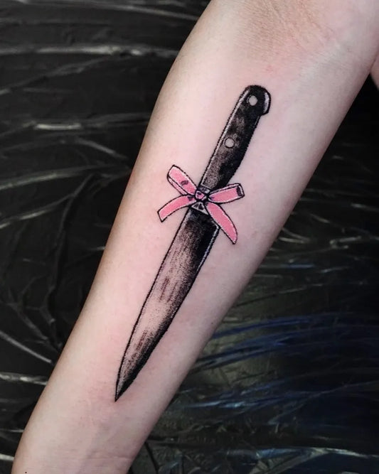 Small Minimalist Knife with Pink Bow Tattoo on Women Forearm by @lofi_tattooer