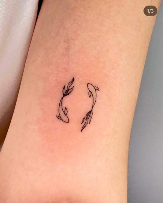 Small Minimalist Koi Fish Tattoo on Women Arm by @jjun_tattoo