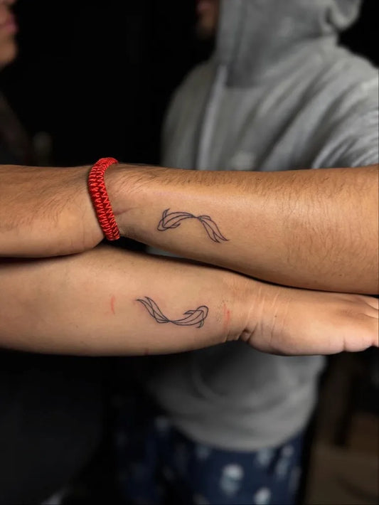 Small Minimalist Koi Fish on Men Wrist Tattoo by @shortyy.ink