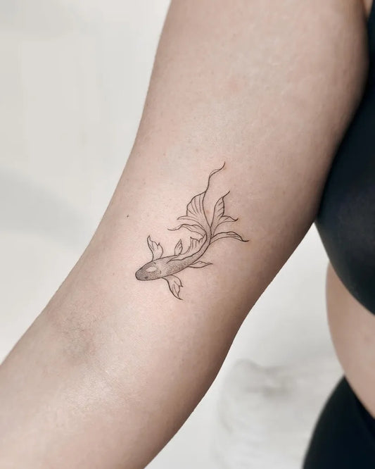 Small Minimalist Koi Fish on Women Arm Tattoo by @cha.tattoo