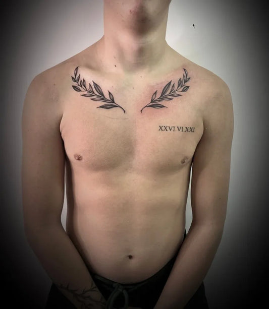 Small Minimalist Laurel Branch Roman Numerals on Men Chest Tattoo by @kd_limitless_