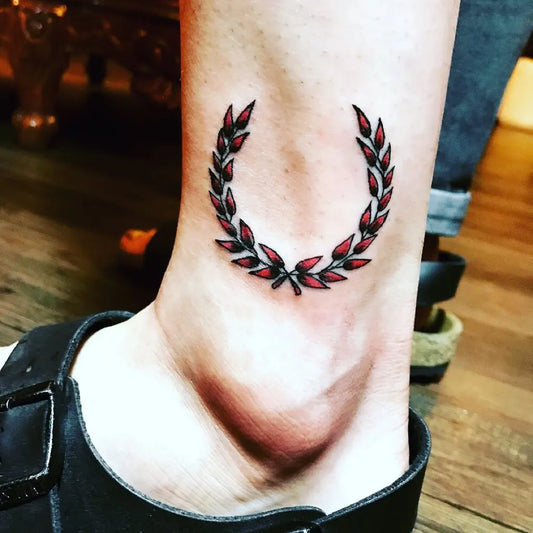 Small Minimalist Laurel Wreath Tattoo on Women Ankle by @mikikang_seoul