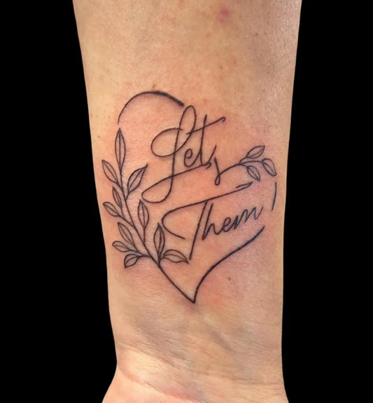 Small Minimalist Let Them Heart Leaves on Women Wrist Tattoo by @barbwiretattoos
