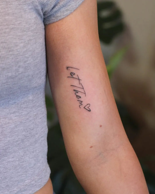 Small Minimalist Let Them Heart on Women Arm Tattoo by @faithfulimpressions.ash