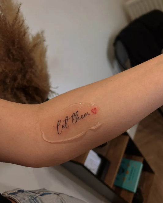 Small Minimalist Let Them Heart on Women Arm Tattoo by @tinytatswigan
