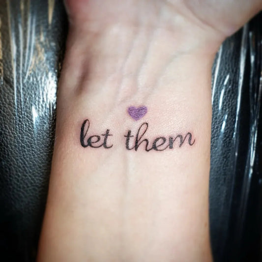Small Minimalist Let Them Heart on Women Wrist Tattoo by @marsdoestattoos
