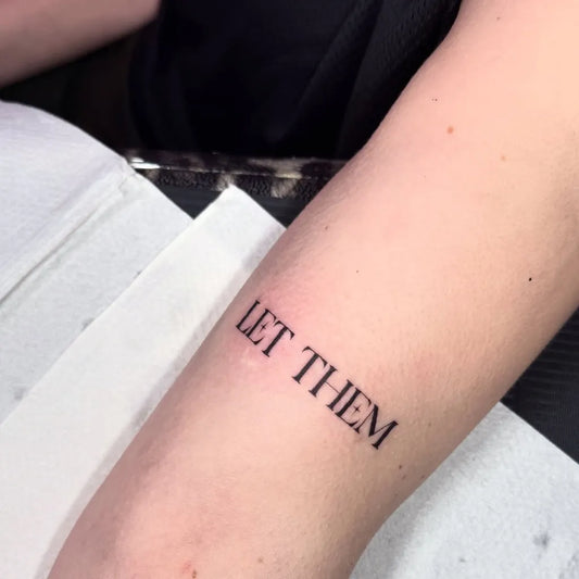 Small Minimalist Let Them Text on Women Arm Tattoo by @georgianicoletattoo