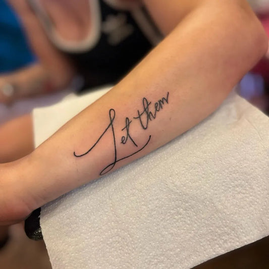 Small Minimalist Let Them on Women Arm Tattoo by @altatt_