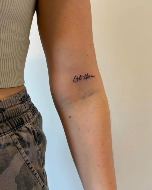 Small Minimalist Let Them on Women Arm Tattoo by @es_thestudio