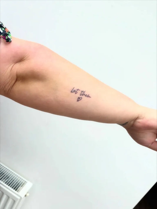 Small Minimalist Let Them on Women Arm Tattoo by @tiny.tattoos.by.lily