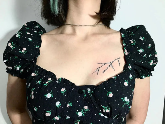 Small Minimalist Lightning Bolt Tattoo on Women Chest by @handpoked.tattoos