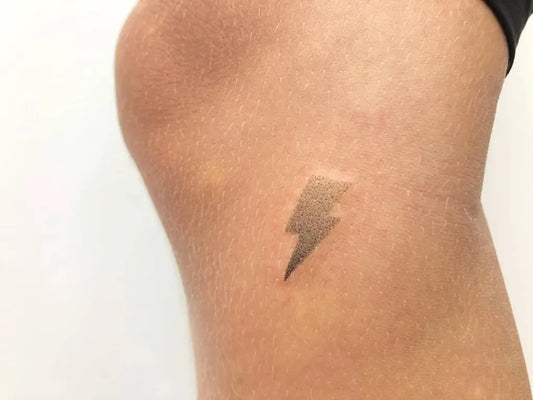 Small Minimalist Lightning Bolt Tattoo on Women Thigh by @sonny_tattooer